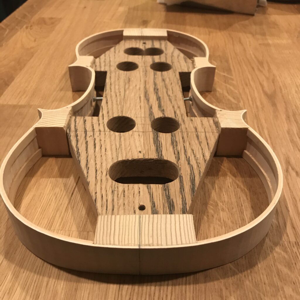 A violin mold in a skeleton shape.