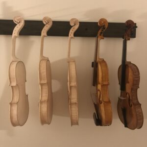 Five violins hanging